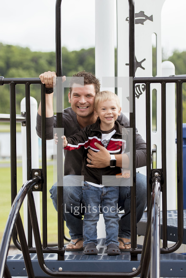 father and son on a playground 