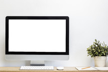 blank computer screen on a desk 
