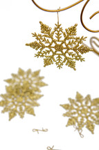 Gold snowflake decorations on white background