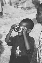 child taking a photograph 