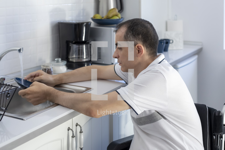 a man in a wheelchair in his kitchen 