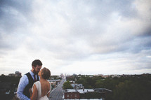 Husband and wife kissing on rooftop