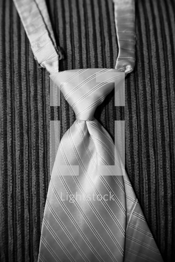 a man's tie hanging over a chair