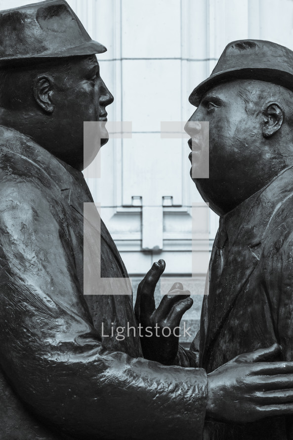 statues of Men in conversation 