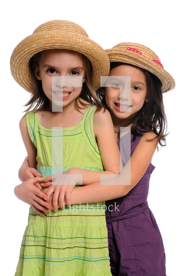 Two little girls wearing hats.