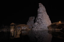 dock and huts in a village by water at night 