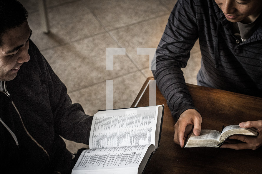 Two men reading at a Bible study.
