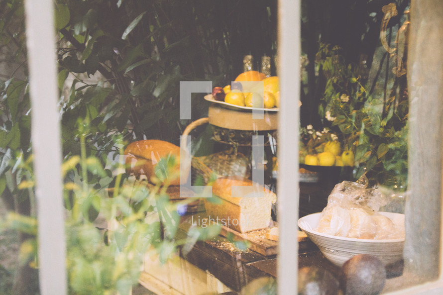 view of bread and lemons through a kitchen window 