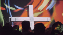 crowd gathered around a cross 