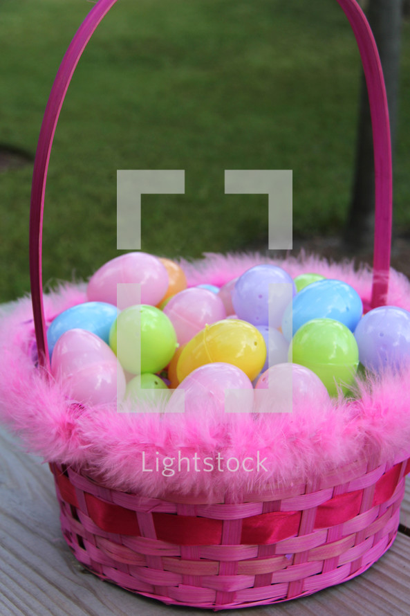 pink Easter basket full of eggs