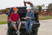contractors planning in a truck bed 