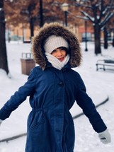 a girl in a coat in snow 