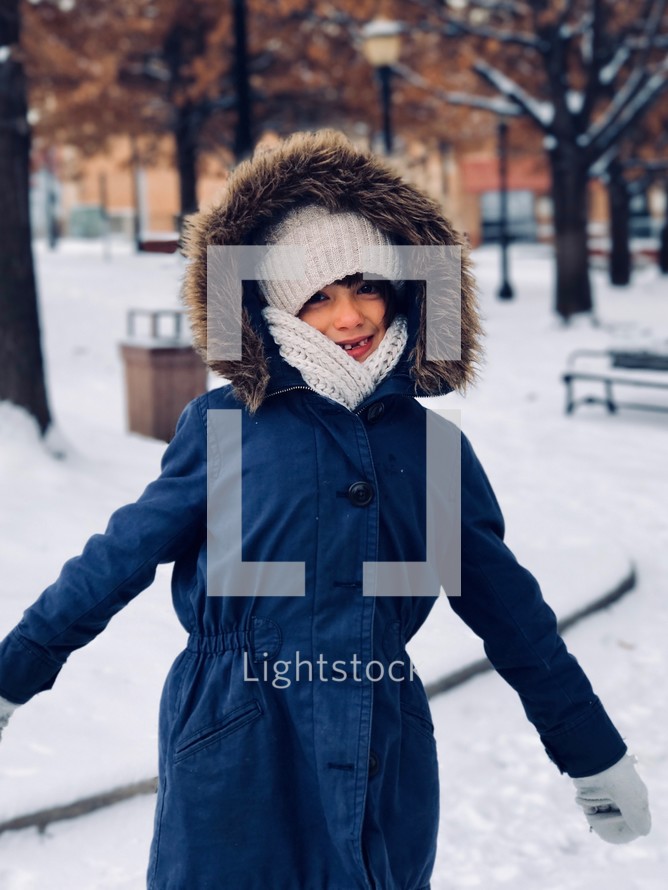a girl in a coat in snow 