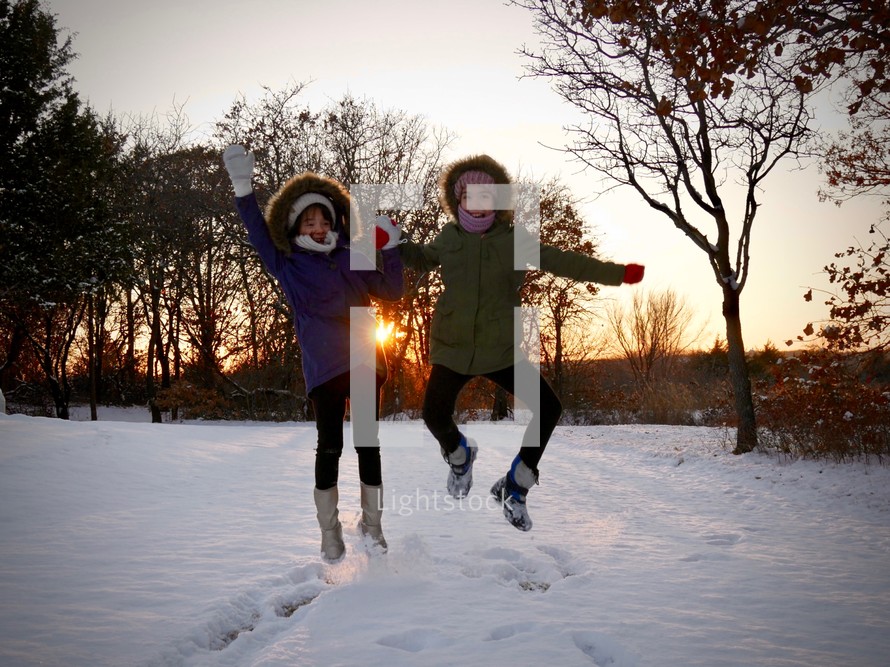 kids jumping in snow 