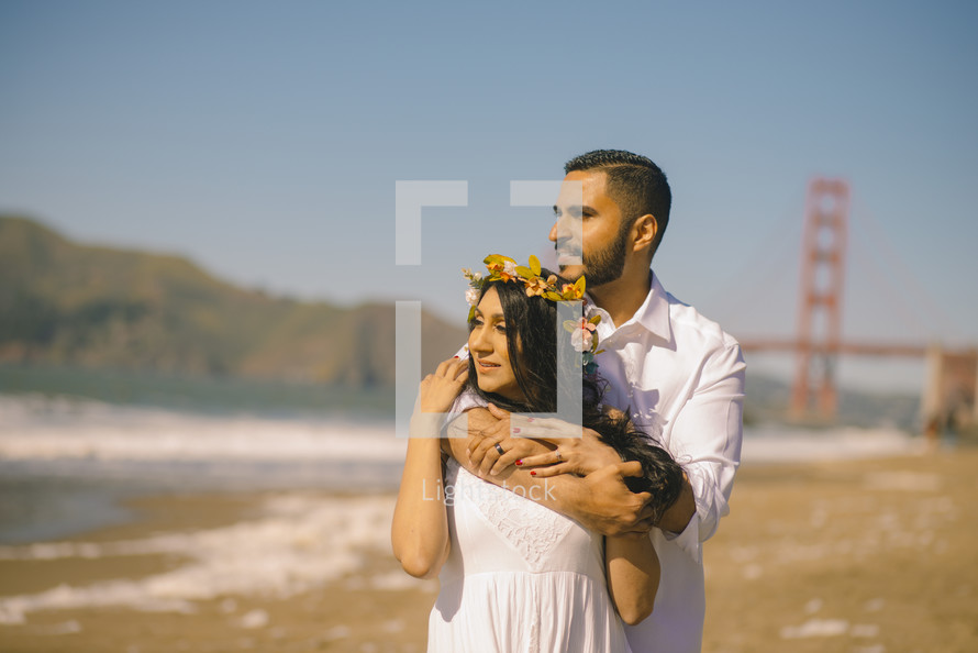 a couple standing on a beach in San Francisco 
