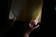 Woman flipping through BIble pages
