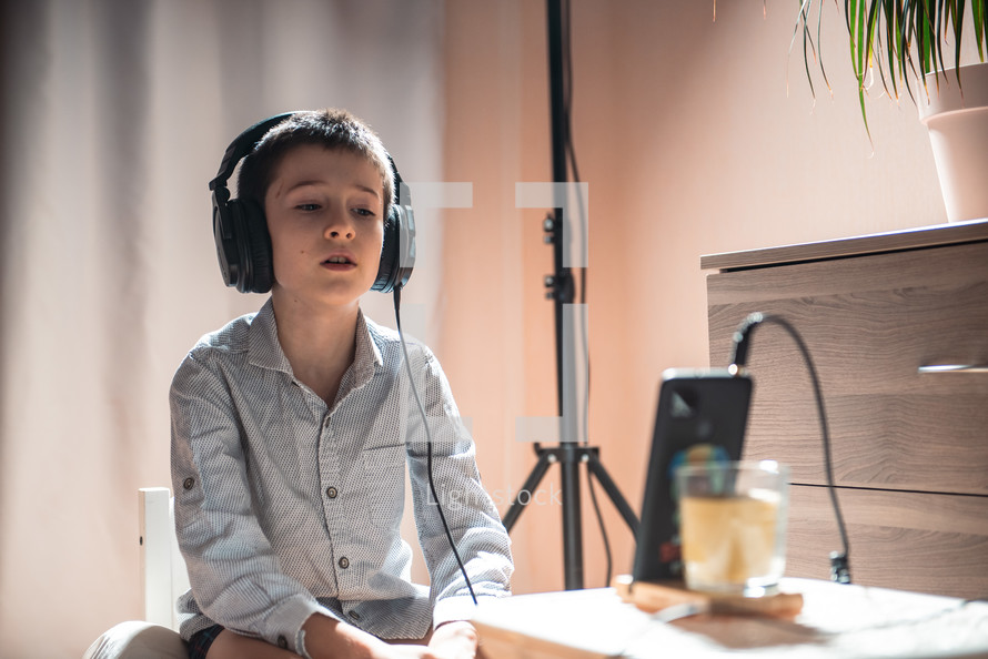 a child in a recording studio with headphones 