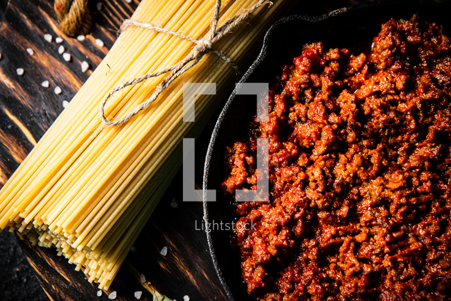 Bolognese sauce with pasta . On a rustic background