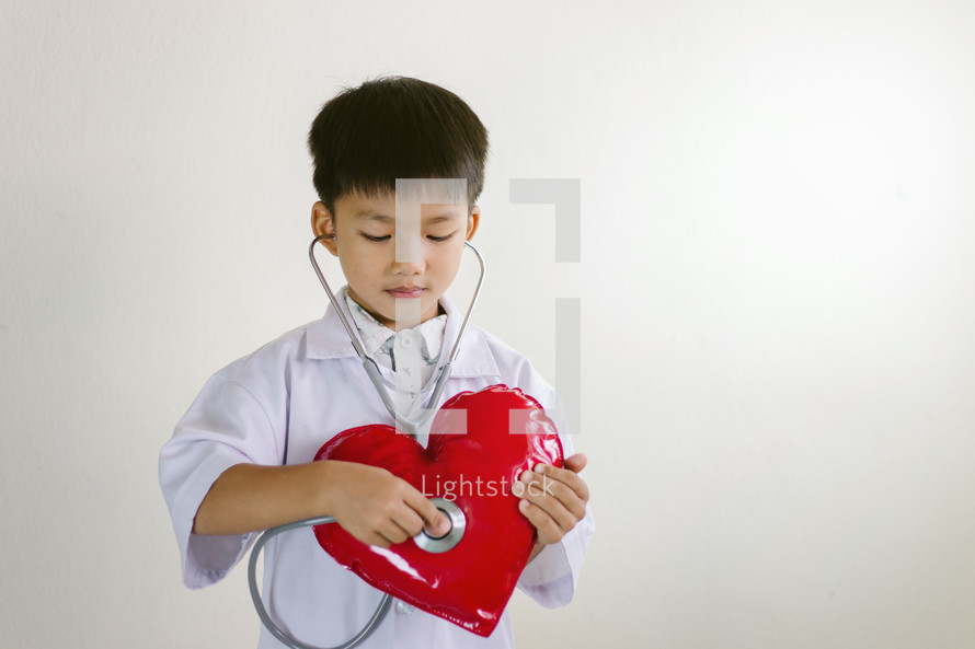 kid with a stethoscope and heart 