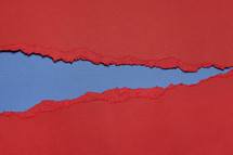 Blue beneath  torn red paper.