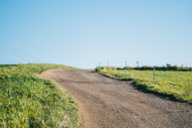 Dirt path through rural field