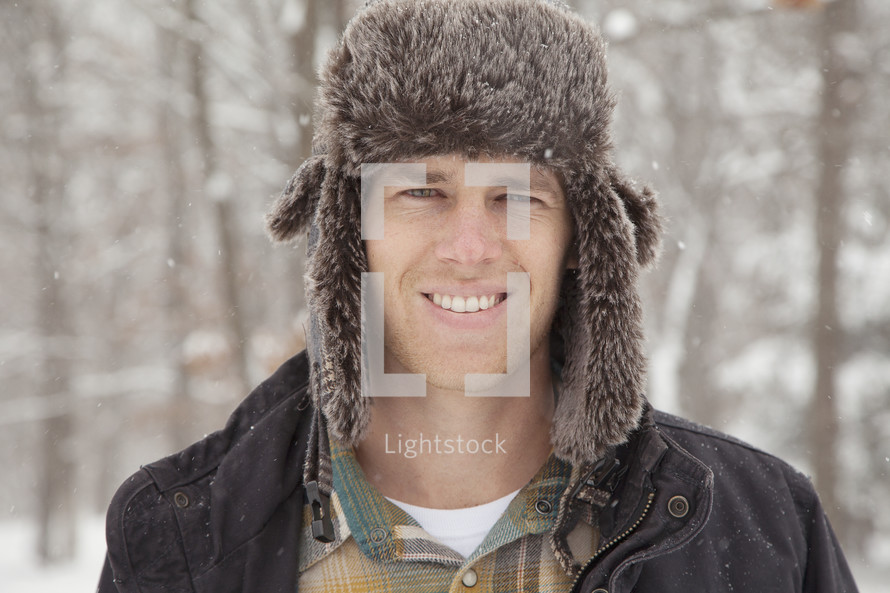 Man in a winter hat outdoors.
