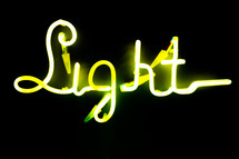  Illuminated letters written light on dark black background. Neon yellow words. Abstract picture. High quality photo
