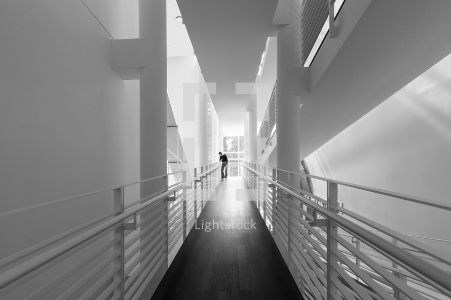 a man at the end of a long hallway 