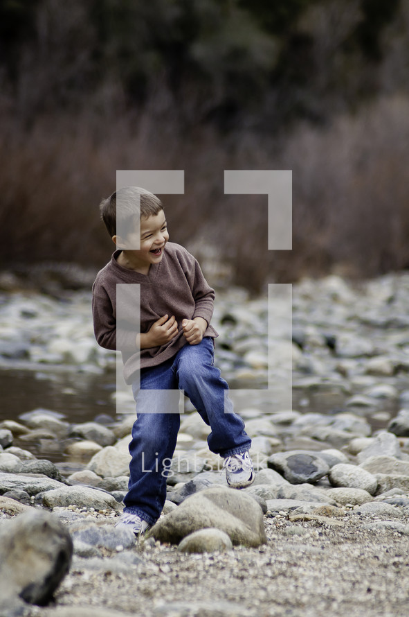 little boy laughing outdoors