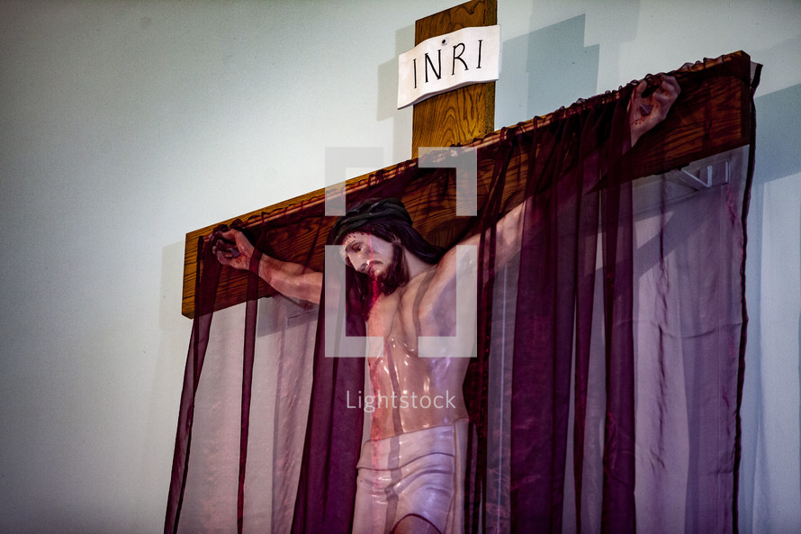 purple shroud over a crucifix 