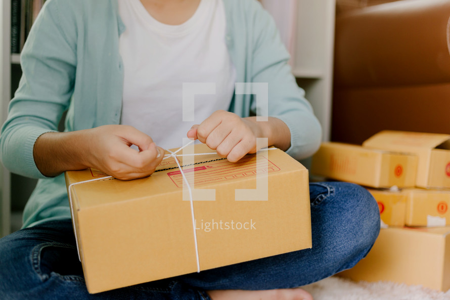 a woman wrapping up a package