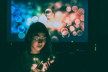 a teen girl holding fairy lights in her hands 