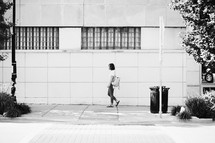 woman walking on a sidewalk 