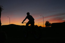 riding a bike at sunset 