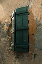 Wooden window shutters on an old building, traditional old architecture, building exterior