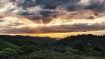 Beautiful sunset sky above wild forest nature in New Zealand mountains evening landscape Time lapse

