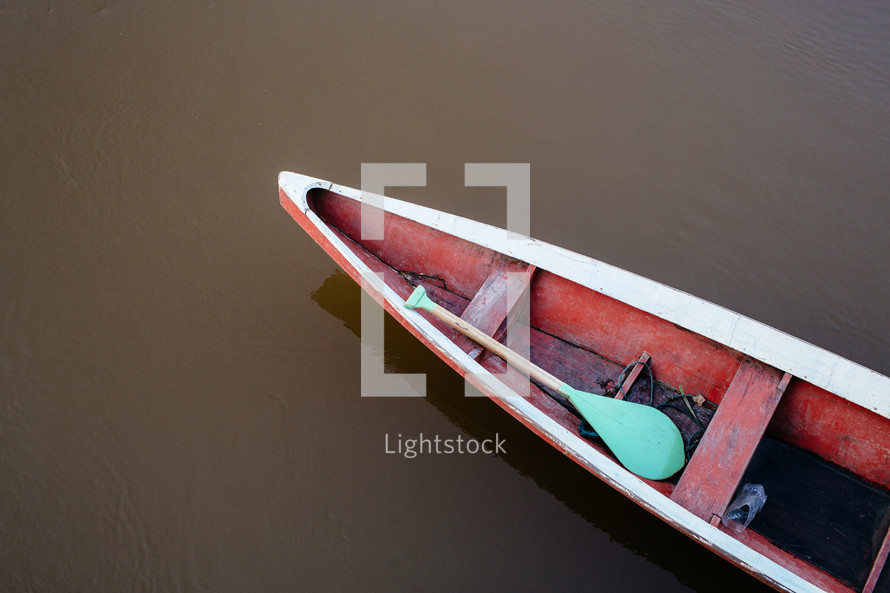 paddles in a boat on the Amazon river 