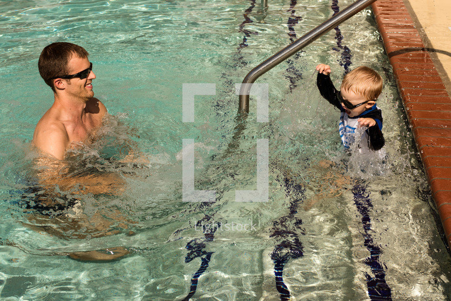 father and son in a swimming pool 