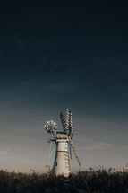 White windmill at night time underneath the night sky, the plough constellation, astrophotography, clear sky, landscape photo