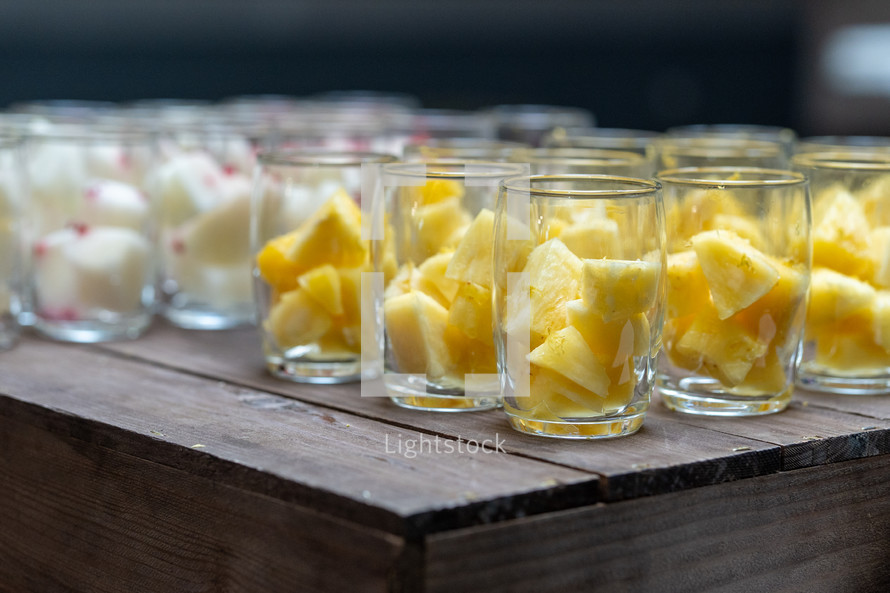 Pineapple slices healthy dessert snack in a glass, artisan fruit servings, watermelon, melon sweet fruits