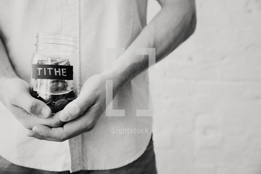 man holding a tithe jar 