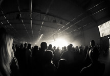 silhouette of audience members at a concert 