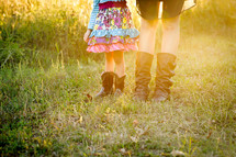 feet of a mother and daughter wearing cowboy boots