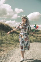 a woman holding a pinwheel 