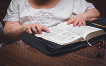  elderly woman reading a Bible 