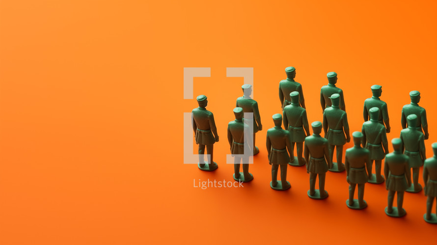 Plastic green army men in formation on an orange background.