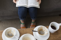 woman witting on a couch reading a Bible and breakfast 
