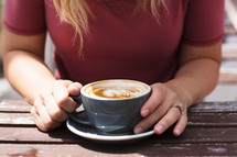 a woman sitting with coffee 
