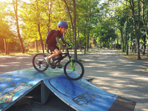 boy on a ramp with a bicycle 