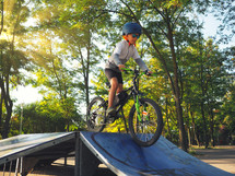 boy on a ramp riding a bike 